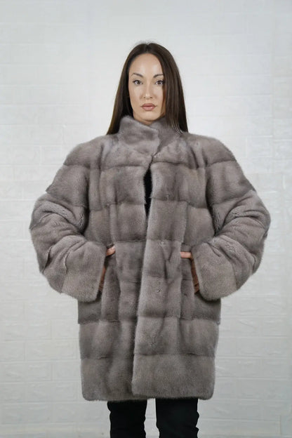 Mink fur coat silver shown from the side displaying above the knee silhouette and luminous silver mink drape from collar to hem — Greek craftsmanship, TatiFurs
