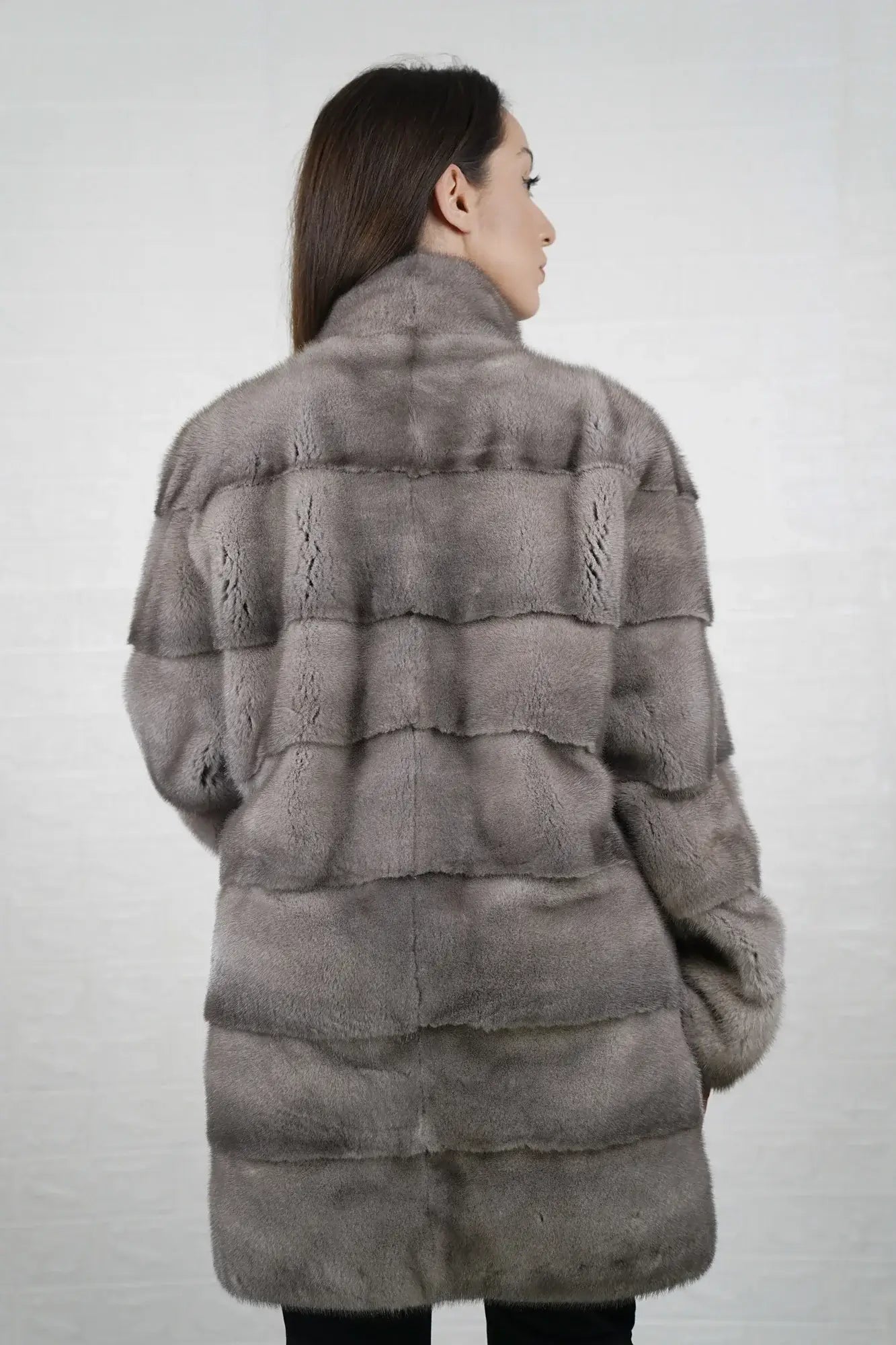 Mink fur coat silver shown from the back displaying full above the knee silhouette and cool luminous silver skin on skin mink flow — Greek craftsmanship, TatiFurs
