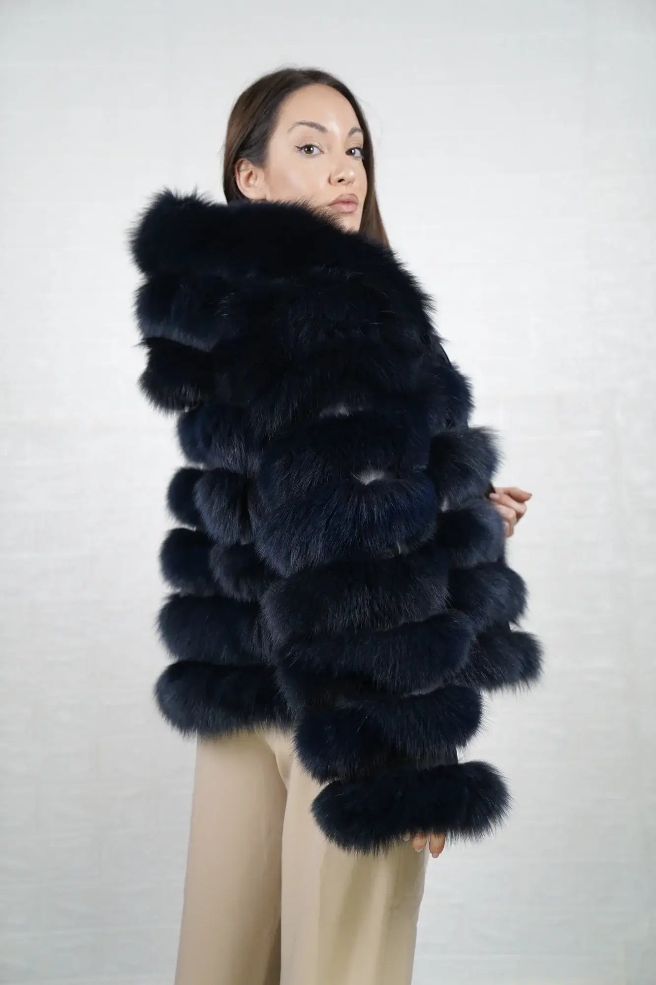 Fox fur jacket blue hood worn up showing velvet lined hood interior framing face against luminous blue fox leather trim exterior — Greek craftsmanship, TatiFurs
