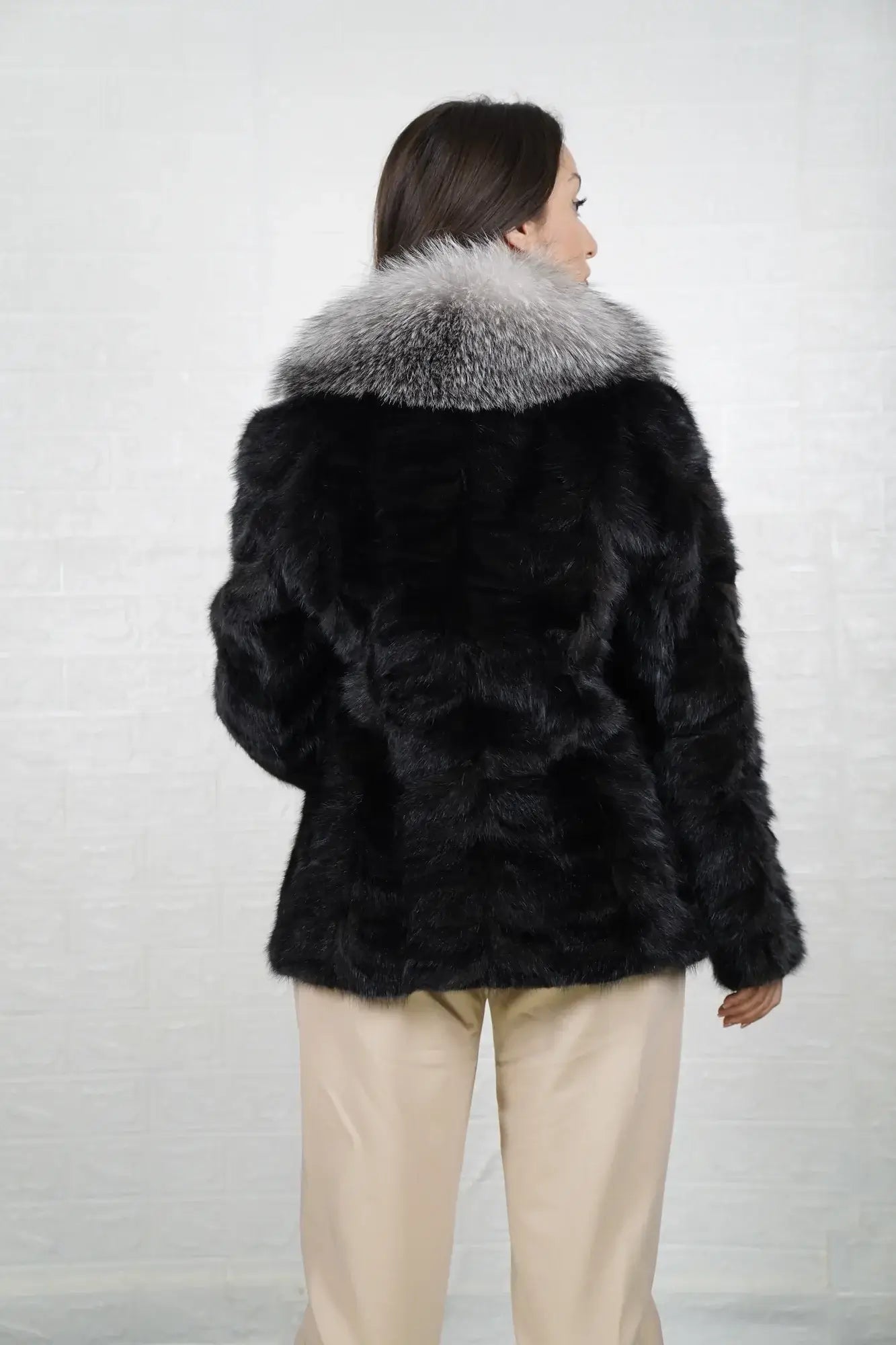 Mink fur jacket black fox collar shown from the back displaying full hip level silhouette and uniform black patchwork mink surface — Greek craftsmanship, TatiFurs
