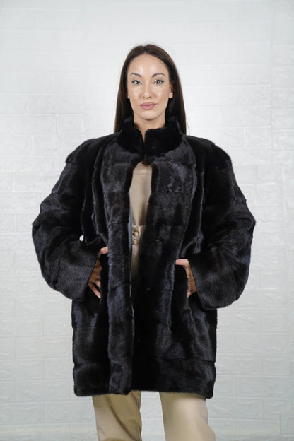 Mink fur coat black shown from the side displaying above the knee silhouette and natural black mink drape from collar to hem — Greek craftsmanship, TatiFurs
