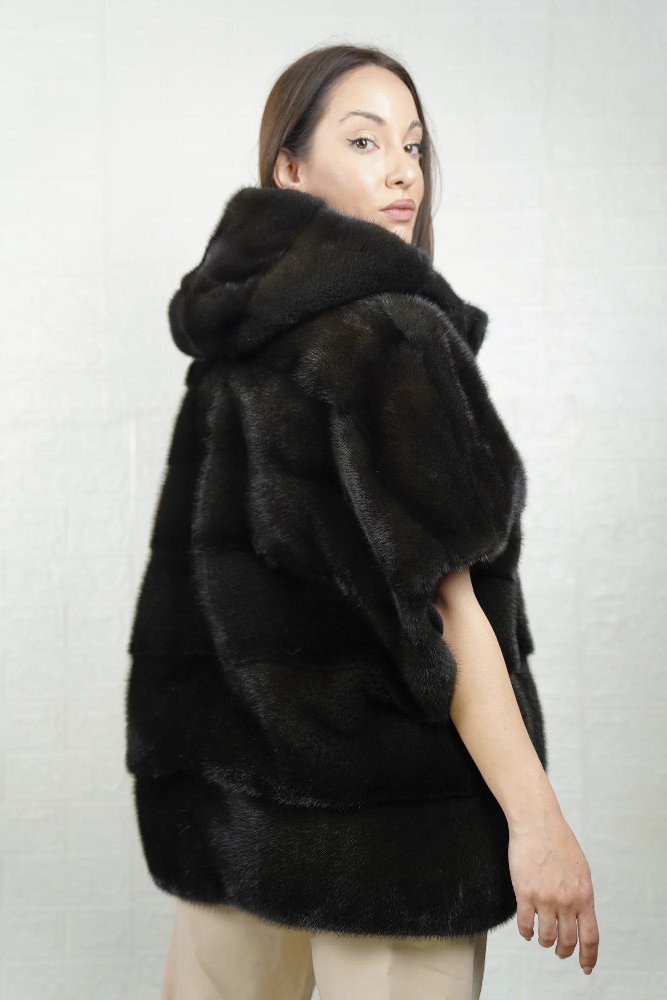 Mink fur cape dark green close-up texture showing skin on skin vertical pelt flow and rich dimensional dark green mink depth
