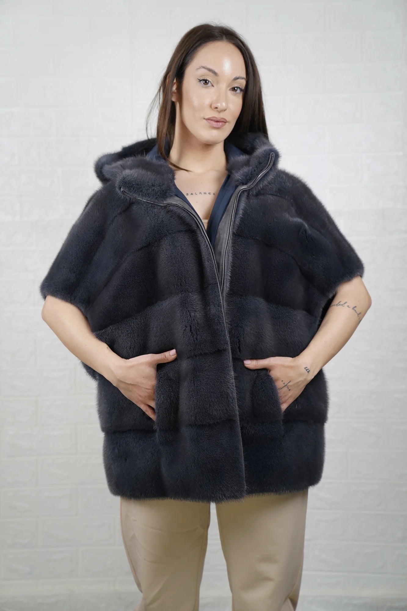 Mink fur cape gray women shown full length from front displaying short sleeved hooded silhouette and cool gray skin on skin flow
