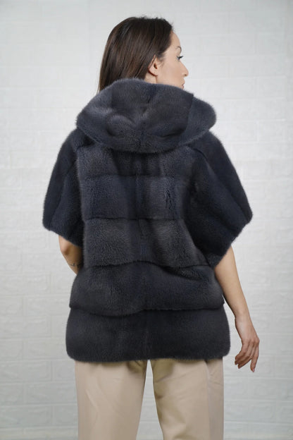 Mink fur cape gray shown from the back displaying hooded short sleeved silhouette and fluid skin on skin cool gray mink drape
