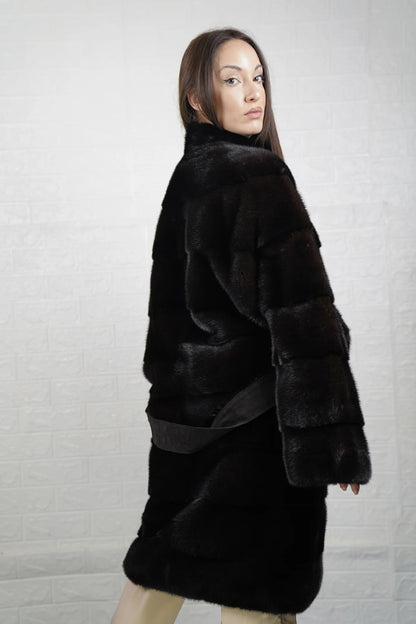 Mink fur coat dark brown collared long with belt close-up texture showing skin on skin pelt flow and deep warm dark brown mink depth — Greek craftsmanship, TatiFurs
