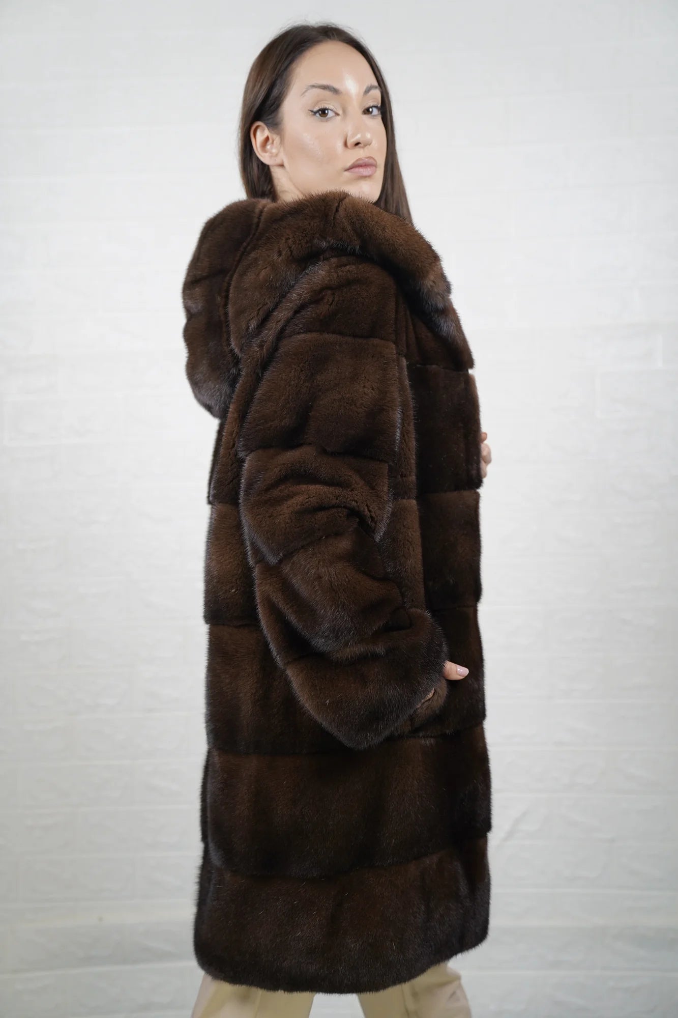 Mink fur coat brown with hood shown from the side displaying above the knee silhouette and natural brown mink drape — Greek craftsmanship, TatiFurs
