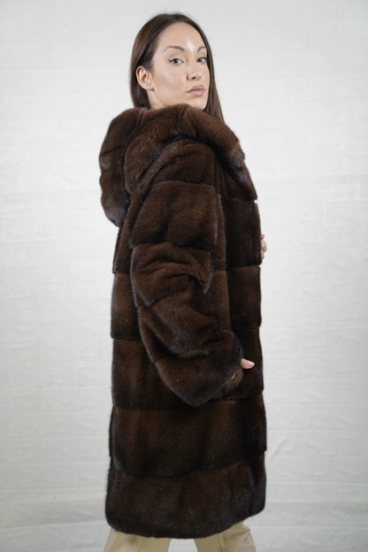 Mink fur coat brown with hood shown from the side displaying above the knee silhouette and natural brown mink drape — Greek craftsmanship, TatiFurs
