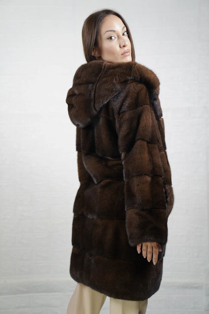 Mink fur coat brown with hood close-up texture showing skin on skin pelt flow and deep warm brown mink depth — Greek craftsmanship, TatiFurs
