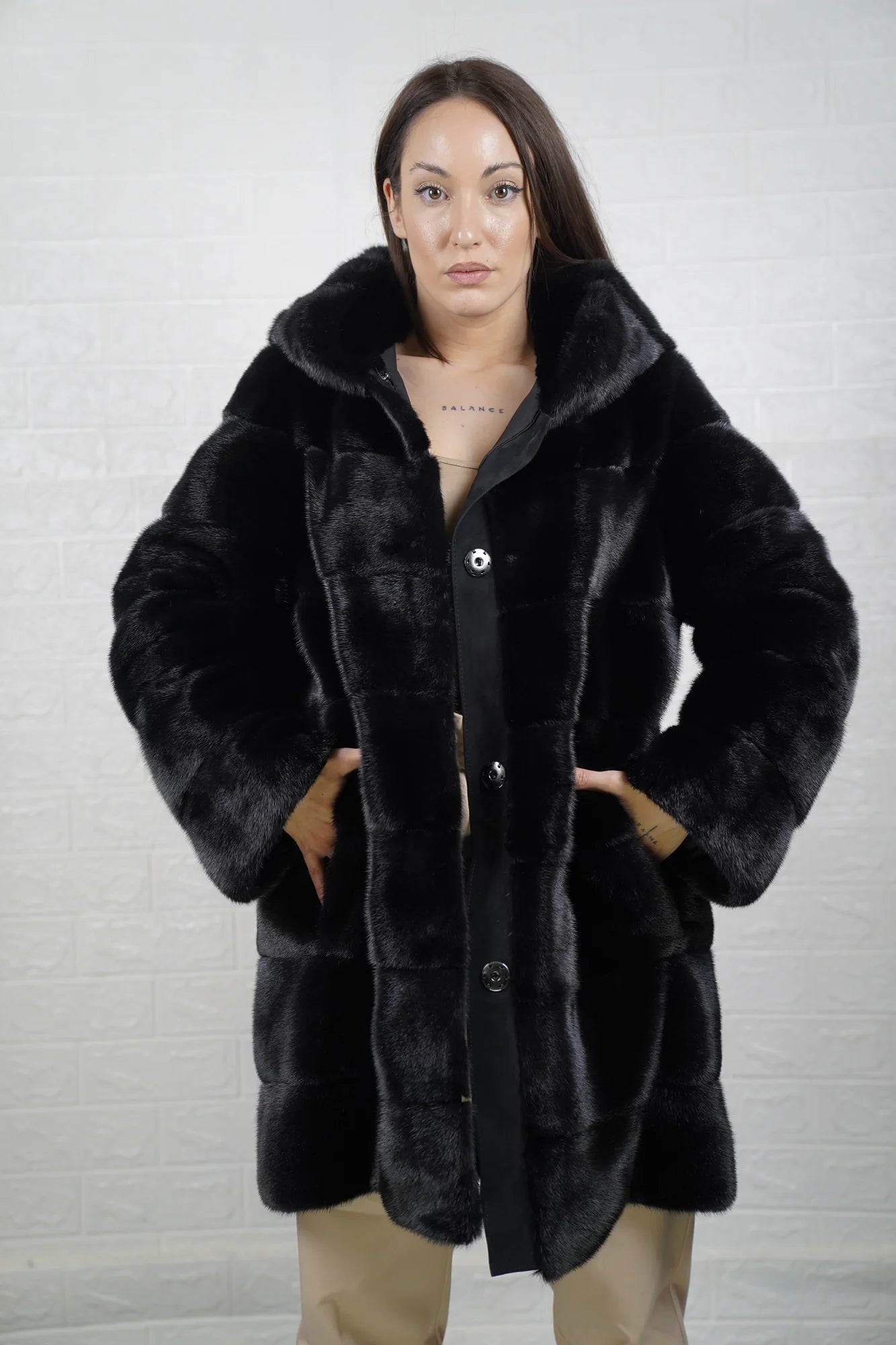 Mink fur coat black with hood close-up texture showing skin on skin pelt flow and deep consistent black mink depth — Greek craftsmanship, TatiFurs

