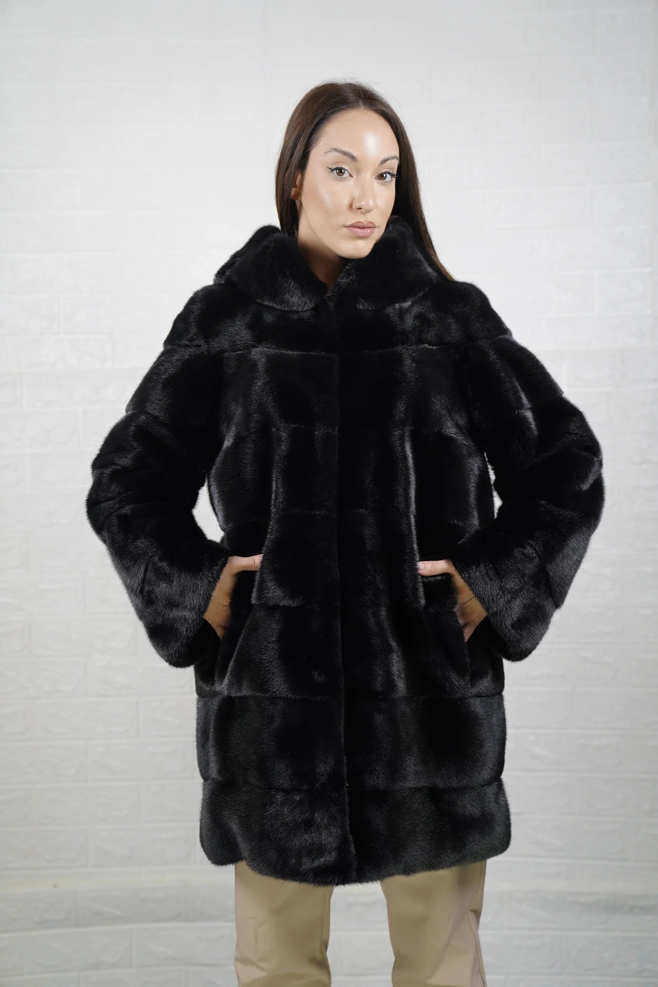 Mink fur coat black with hood shown from the back displaying full above the knee silhouette and deep consistent black skin on skin mink flow — Greek craftsmanship, TatiFurs
