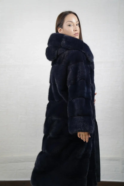 Mink fur overcoat blue shown from the side displaying below the knee overcoat silhouette and natural luminous blue mink drape — Greek craftsmanship, TatiFurs
