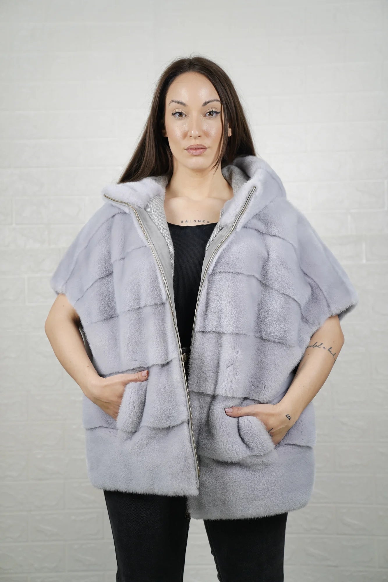 Mink fur cape purple with hood raised showing deep purple mink framing the face and short sleeve construction detail
