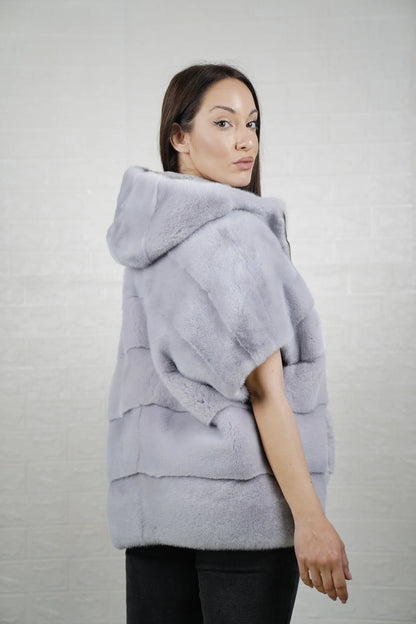 Mink fur cape purple women shown full length from front displaying short sleeved hooded silhouette and deep purple skin on skin flow
