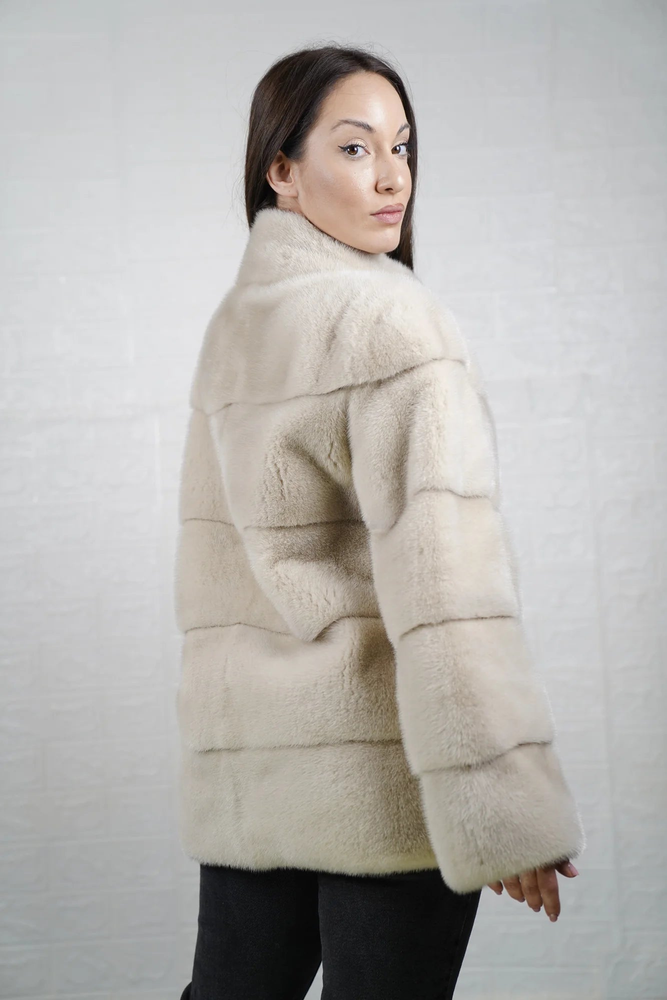 Mink fur jacket light beige close-up texture showing skin on skin vertical pelt flow and warm luminous light beige mink depth
