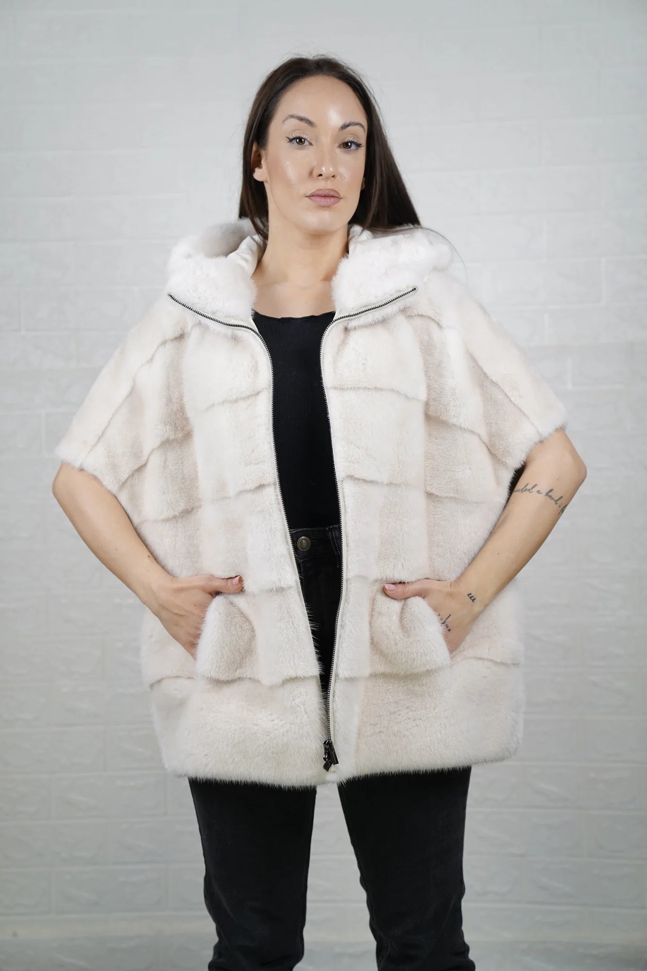 Mink fur cape white with hood raised showing pure white mink framing the face and short sleeve construction detail
