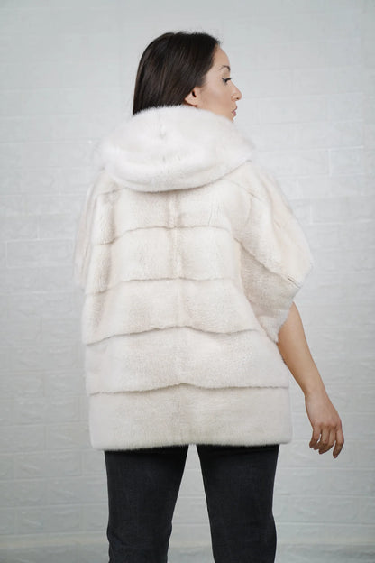 Mink fur cape white shown from the back displaying hooded short sleeved silhouette and fluid skin on skin pure white mink drape
