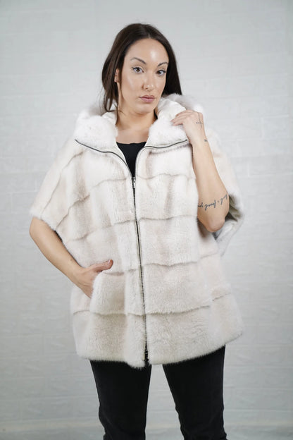 Mink fur cape white women shown full length from front displaying short sleeved hooded silhouette and pure white skin on skin flow
