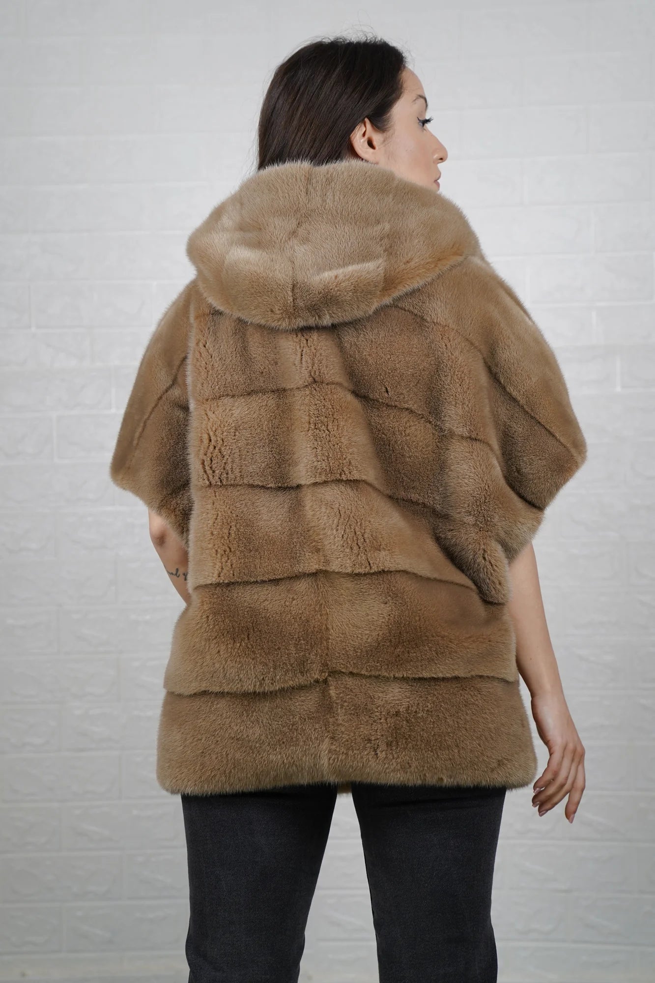 Mink fur cape brown shown from the back displaying hooded short sleeved silhouette and fluid skin on skin natural brown mink drape
