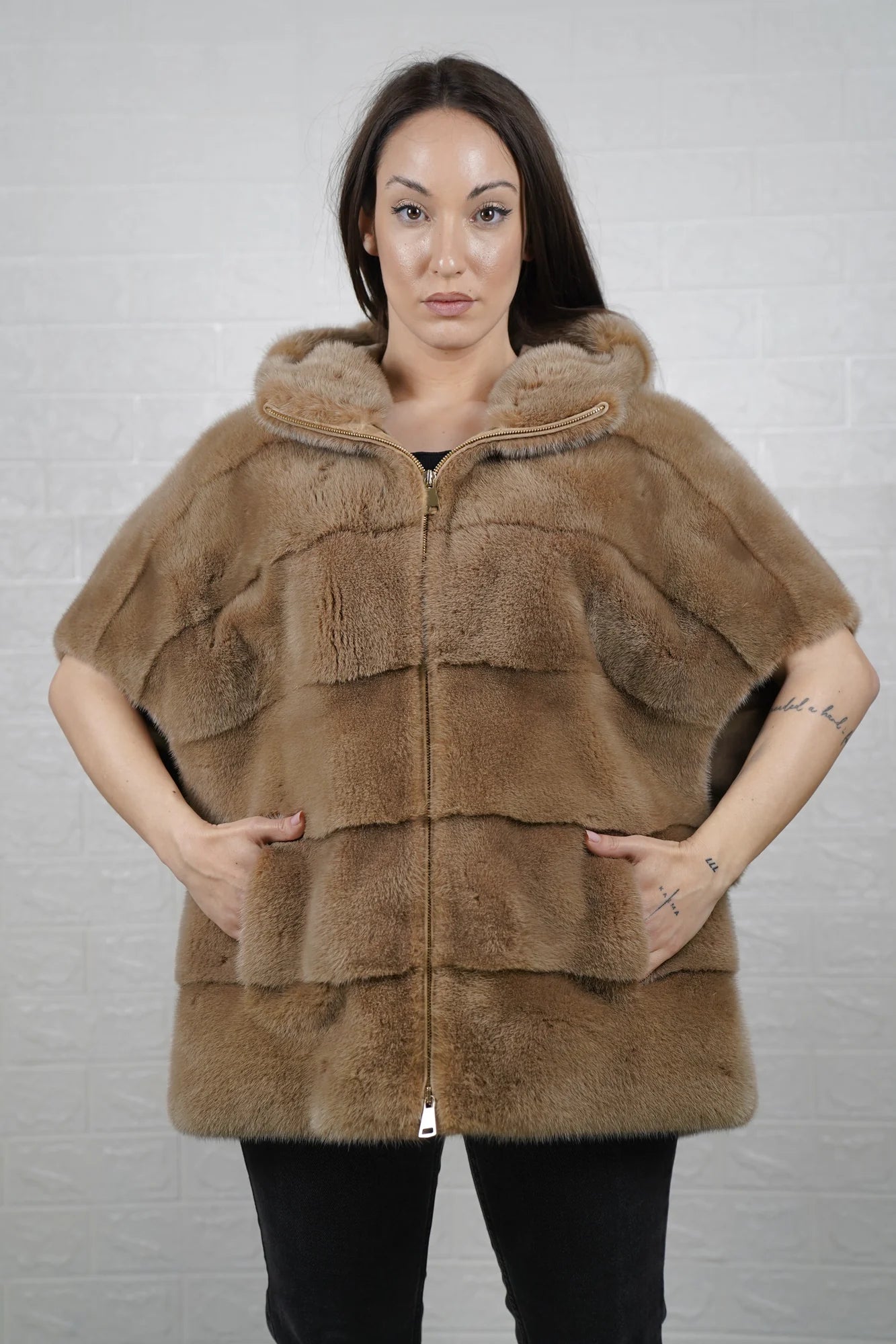 Mink fur cape brown with hood raised showing warm natural brown mink framing the face and short sleeve construction detail
