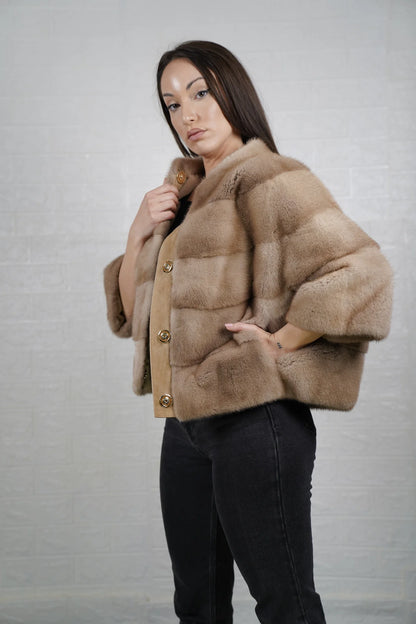 Mink fur jacket brown worn over jeans showing effortlessly modern short bomber silhouette and deep organic warm brown tone
