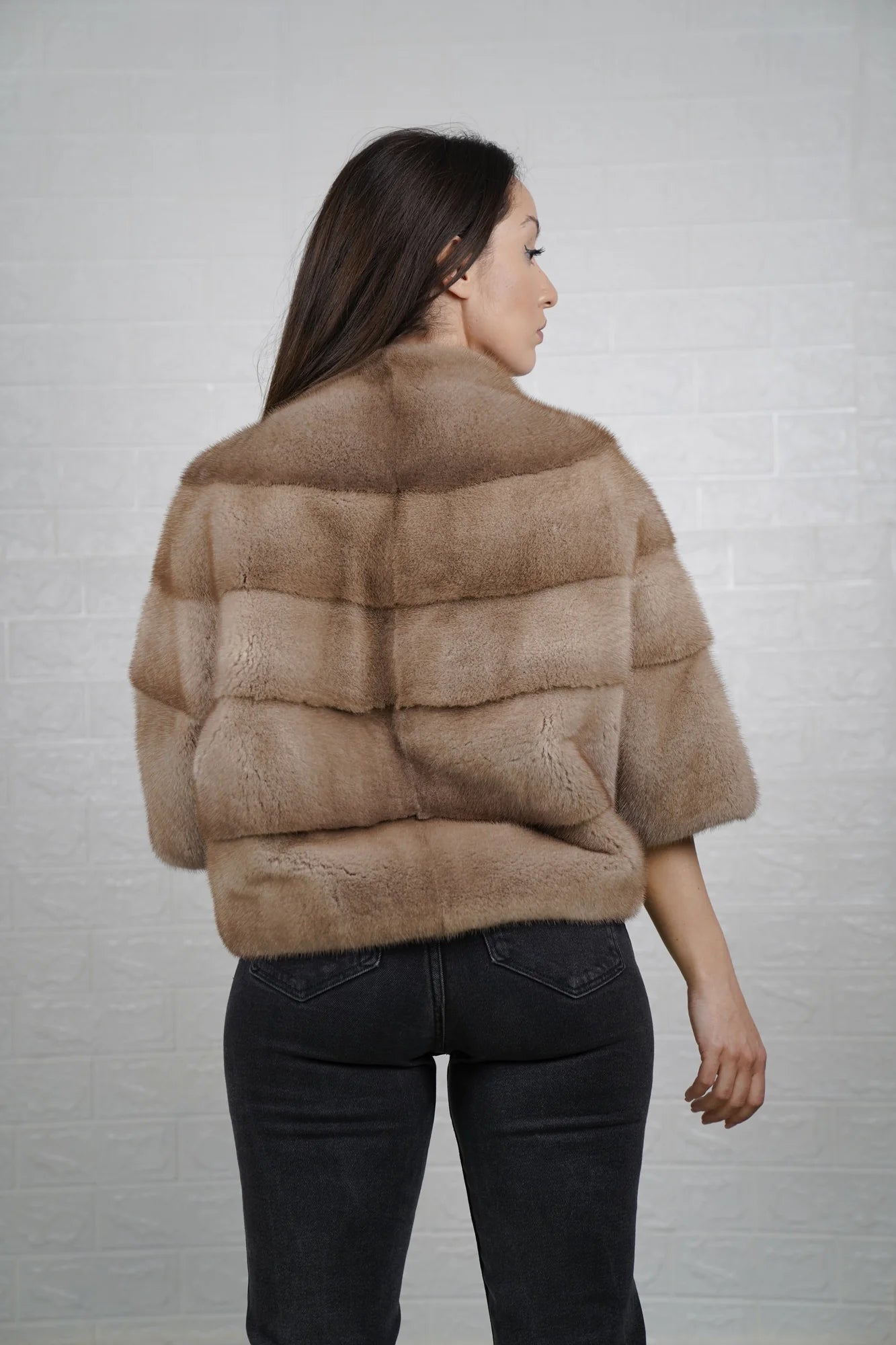 Mink fur jacket brown shown from the back displaying clean short bomber silhouette and deep warm brown skin on skin mink flow
