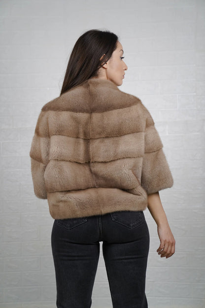 Mink fur jacket brown shown from the back displaying clean short bomber silhouette and deep warm brown skin on skin mink flow
