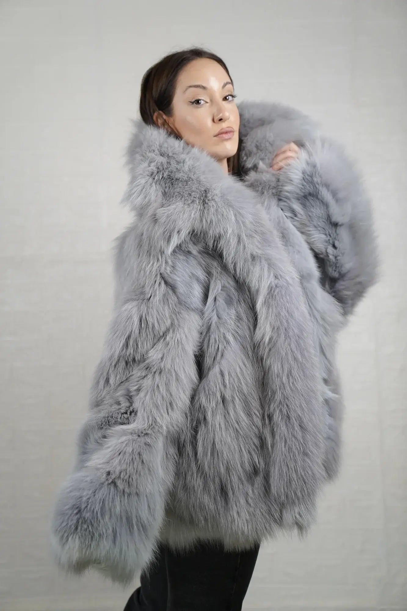 Fox fur jacket gray shown from the side displaying hip level silhouette and cool atmospheric gray fox natural drape — Greek craftsmanship, TatiFurs
