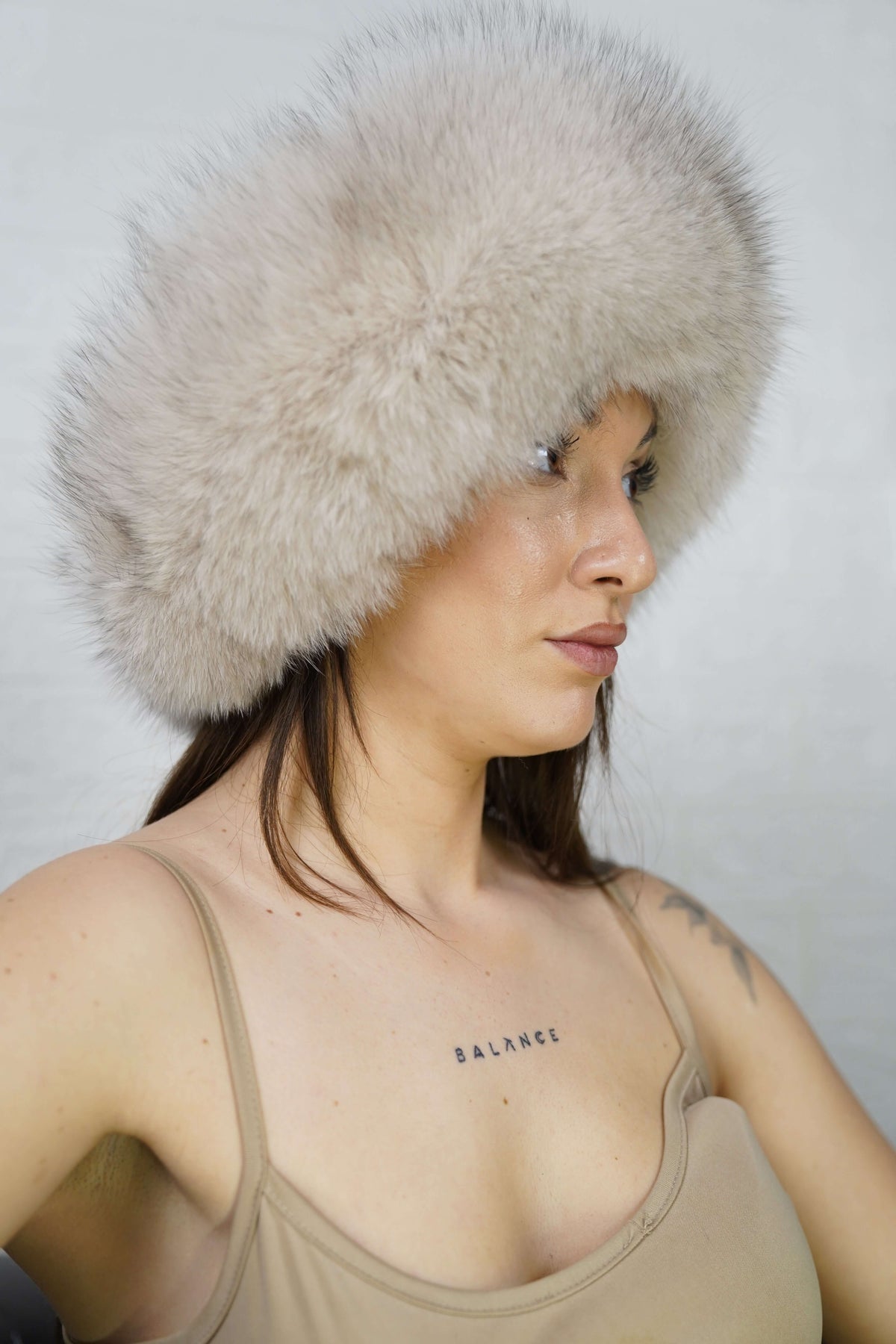 Fox Fur Headband Beige — Full Skin, Elastic worn by a model, showcasing the creamy light beige fur framing the face in winter style — TatiFurs