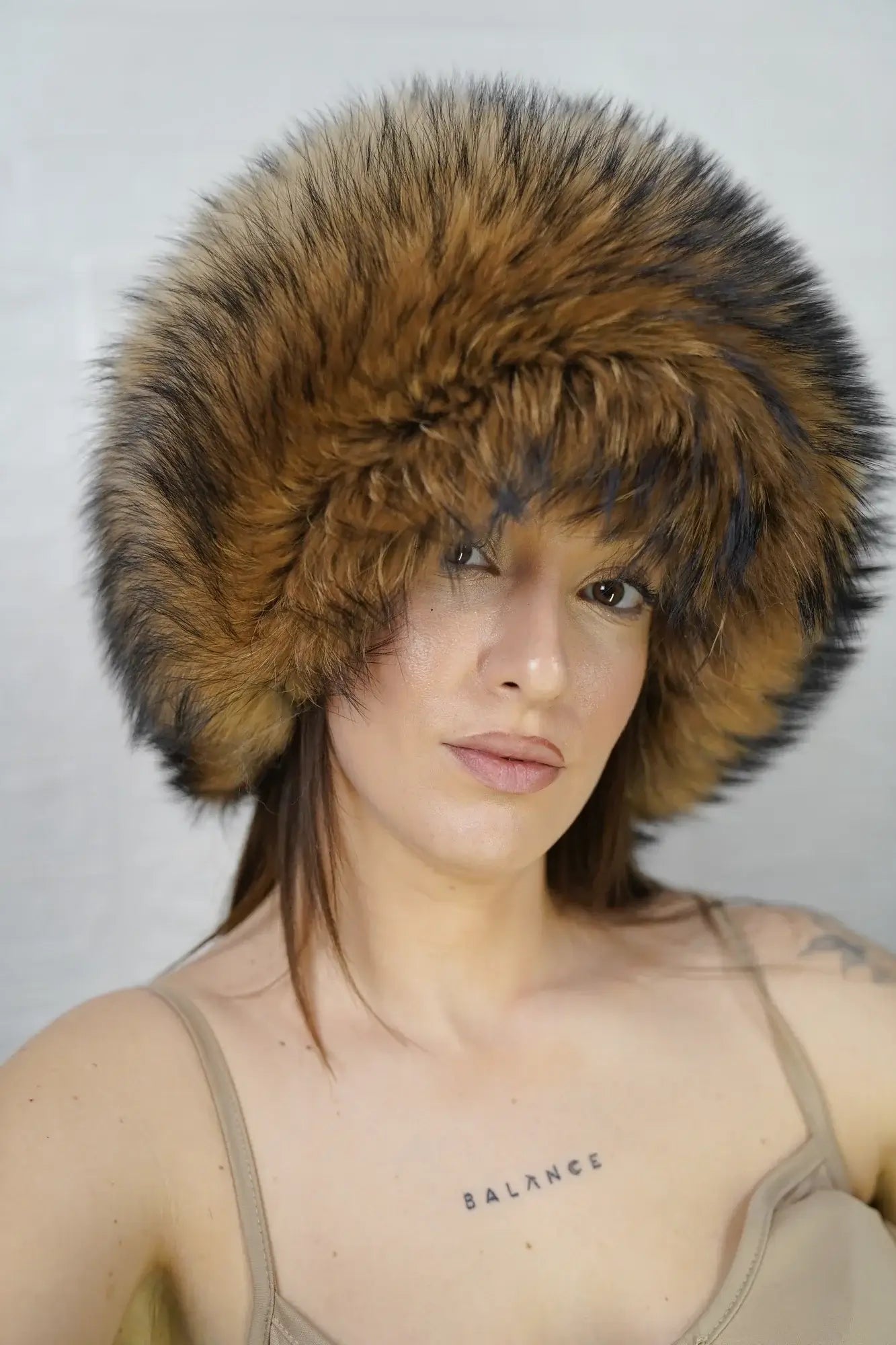 Finn raccoon hat natural displaying voluminous round full skin Finnish raccoon fur silhouette with natural undyed warm tone sitting high on the head — Greek craftsmanship, TatiFurs
