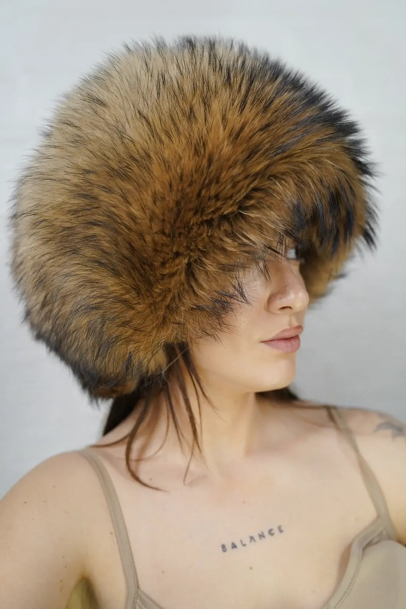 Finn raccoon hat natural close-up texture showing full skin Finnish raccoon long dense pile depth and natural warm undyed tonal variation — Greek craftsmanship, TatiFurs
