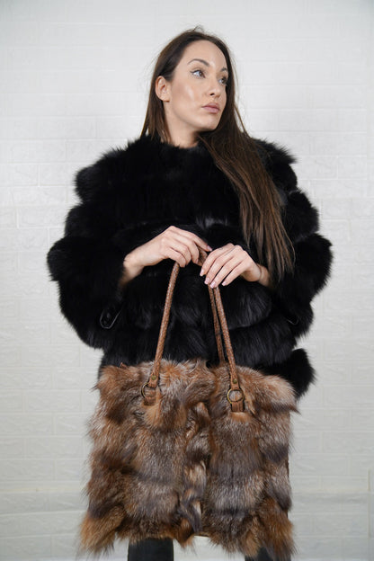 Fox Fur Bag Natural Crystal — Large Tote, Leather Handles — front view held by a model in a black fox fur jacket, brown braided leather handles, TatiFurs