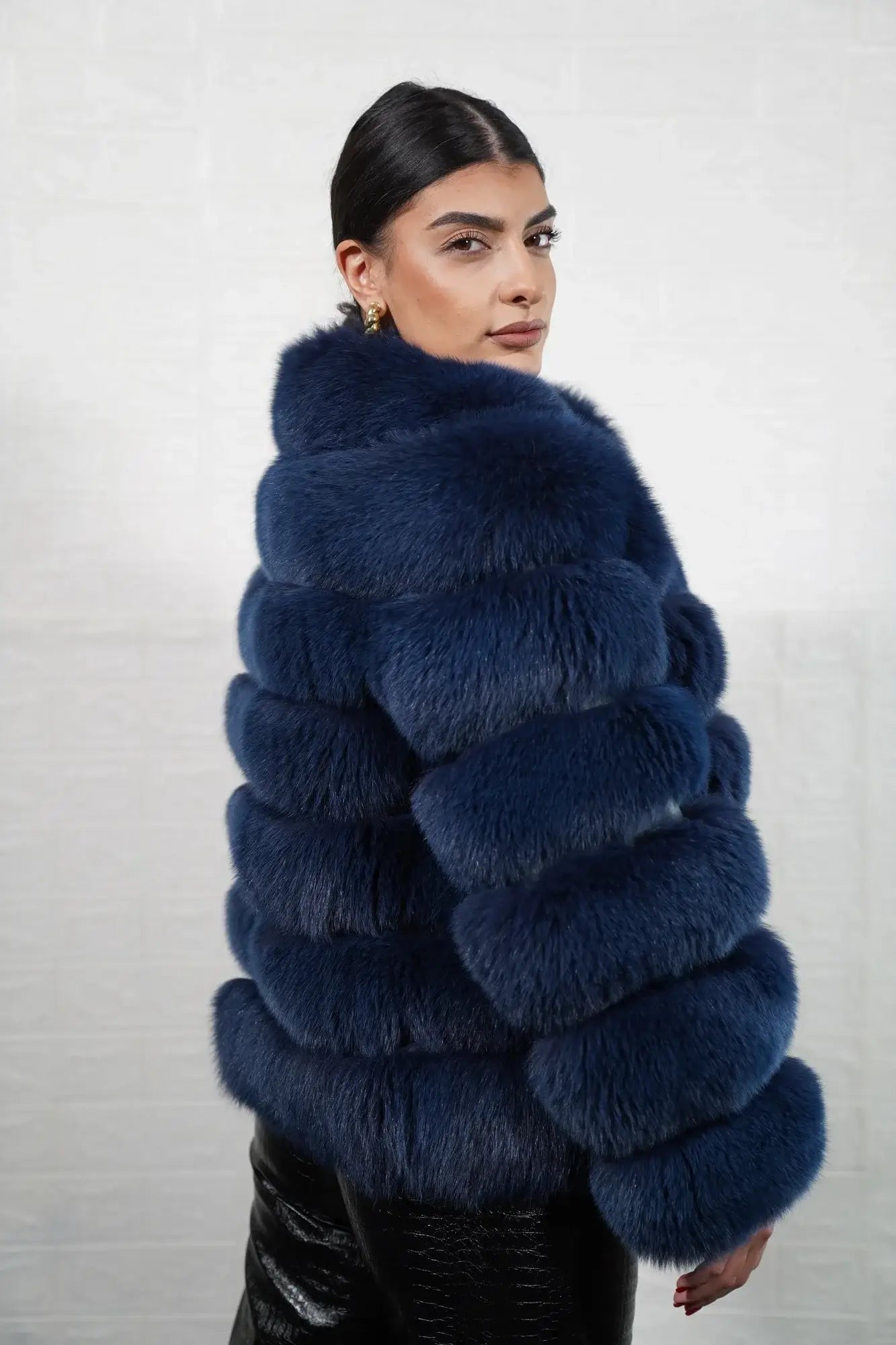 Fox fur jacket blue shown from the side displaying hip level silhouette and horizontal leather framed blue fox rows — Greek craftsmanship, TatiFurs
