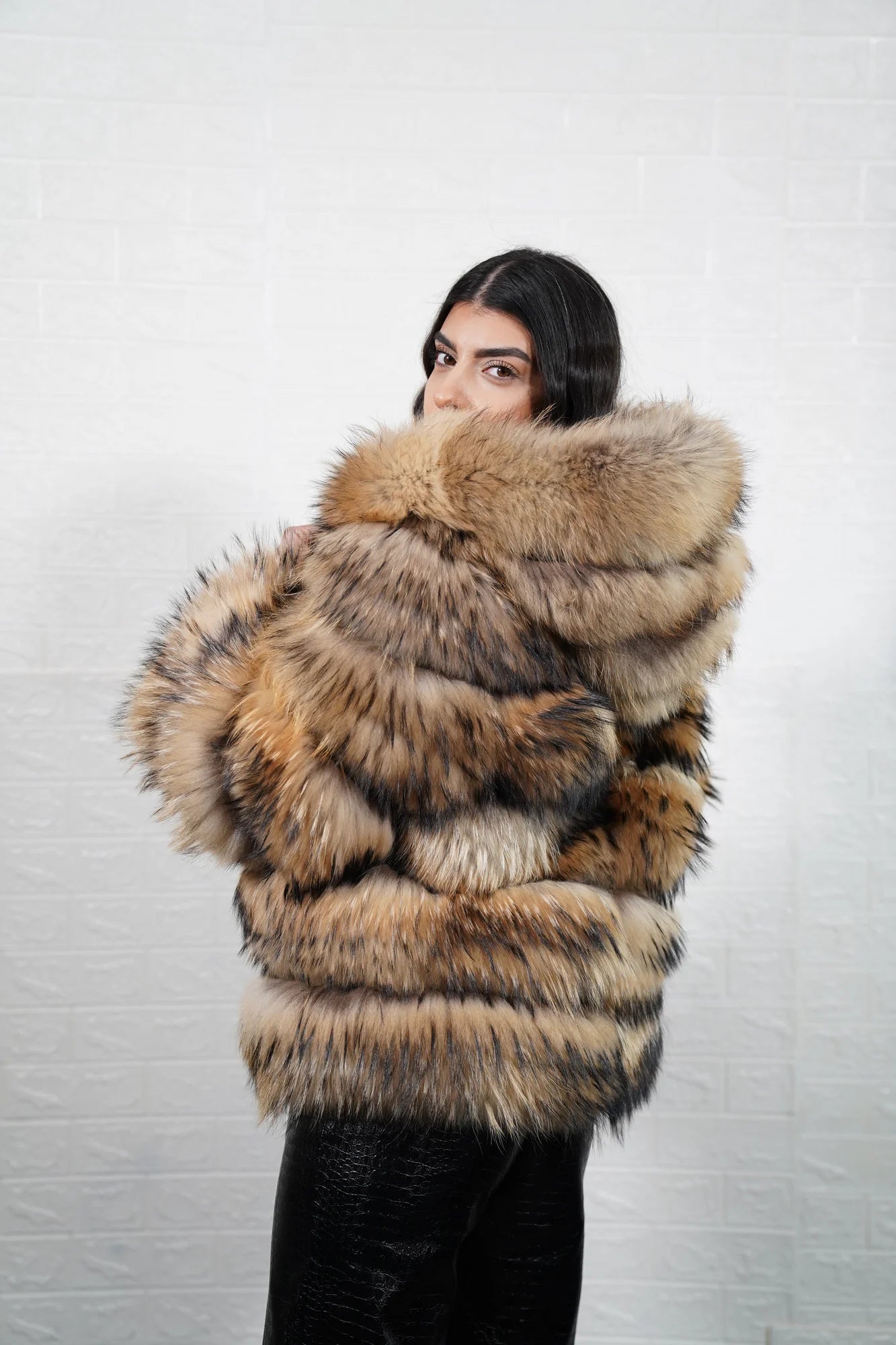 Finn raccoon fur jacket natural shown from the side displaying hip level silhouette and horizontal leather framed dramatic Finnish raccoon rows — Greek craftsmanship, TatiFurs
