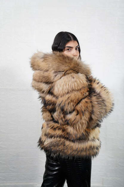Finn raccoon fur jacket natural displaying full skin Finnish raccoon horizontal rows with clean leather strips and hip level hooded silhouette — Greek craftsmanship, TatiFurs
