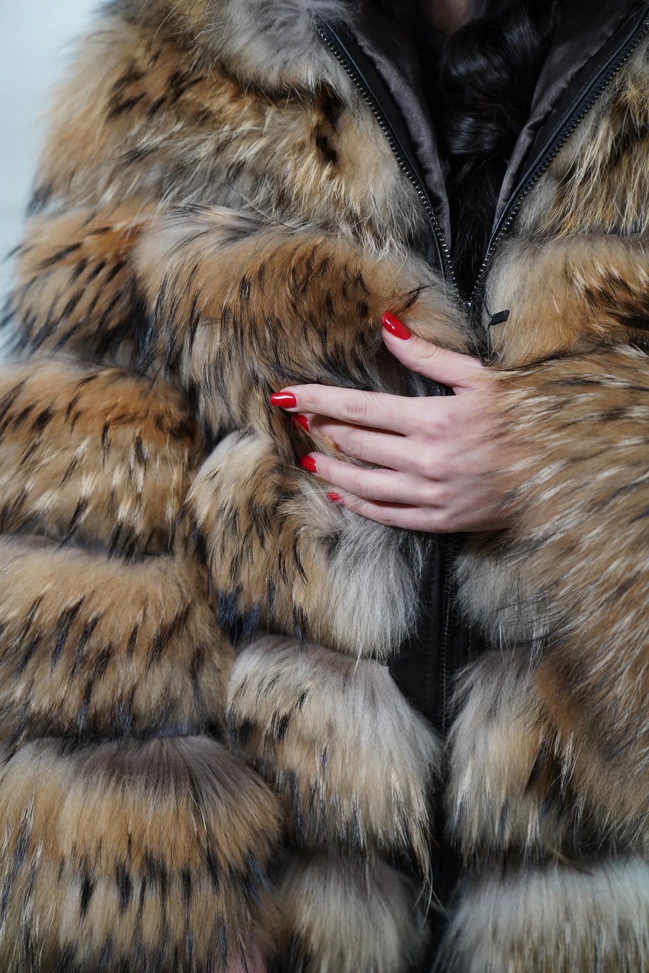 Finn raccoon fur jacket natural hood worn up showing velvet lined hood interior framing face against dramatic natural Finnish raccoon leather trim exterior — Greek craftsmanship, TatiFurs
