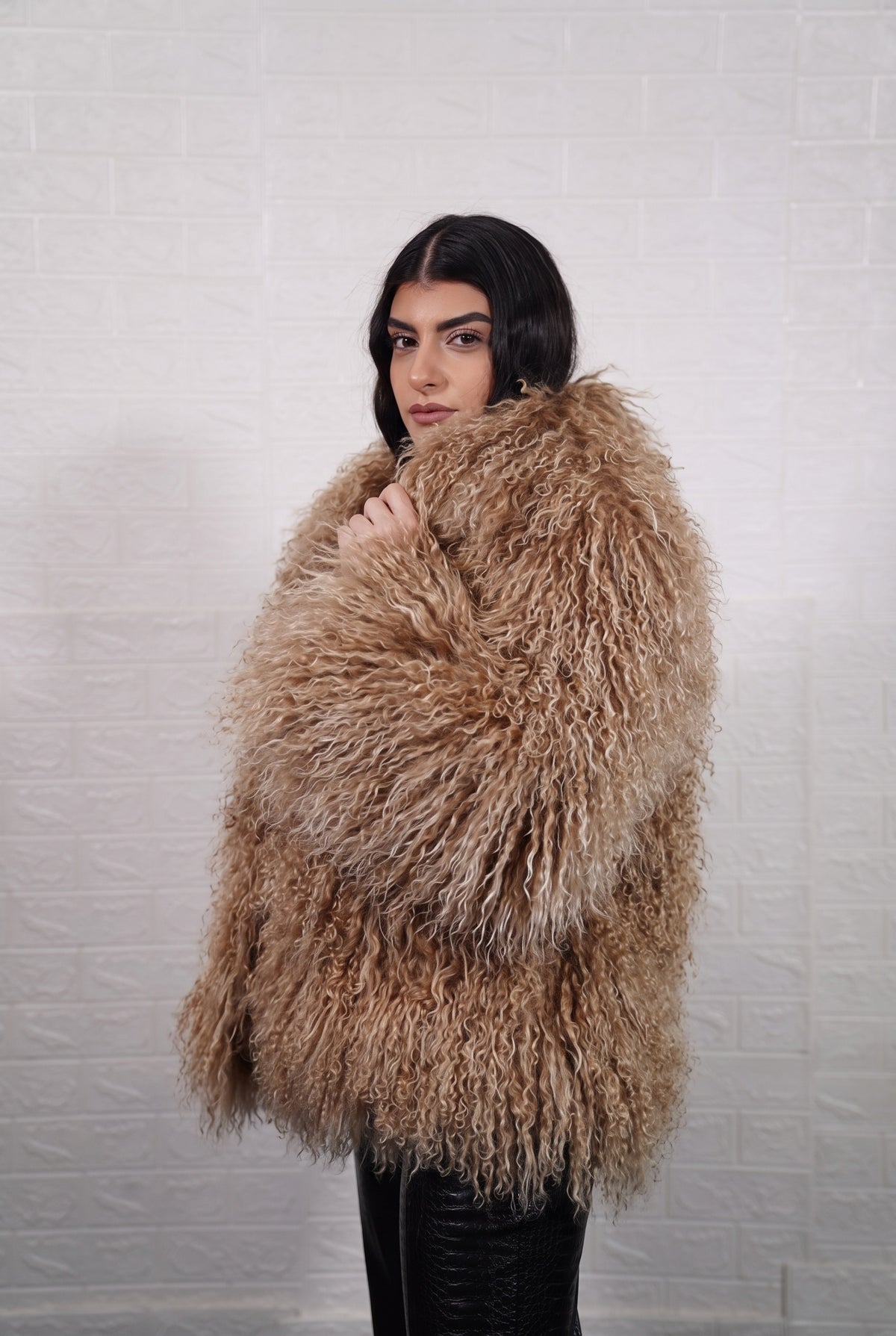 Mongolian jacket light brown shown from the side displaying hip level silhouette and warm honey light brown long curly Mongolian wool — Greek craftsmanship, TatiFurs