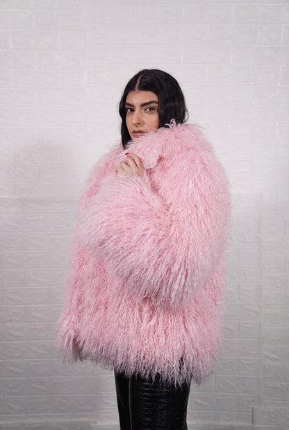 Mongolian jacket pink shown from the side displaying hip level silhouette and soft blush pink long curly Mongolian wool — Greek craftsmanship, TatiFurs