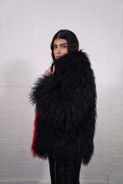 Mongolian jacket red black shown from the side displaying hip level silhouette and bold scarlet red with jet black long curly Mongolian wool — Greek craftsmanship, TatiFurs