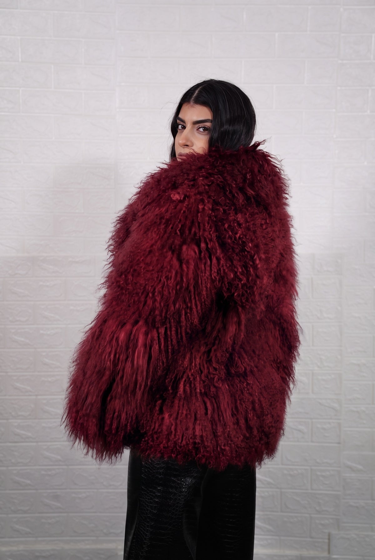 Mongolian jacket burgundy shown from the back displaying full hip level silhouette and consistent deep wine burgundy curly wool surface — Greek craftsmanship, TatiFurs
