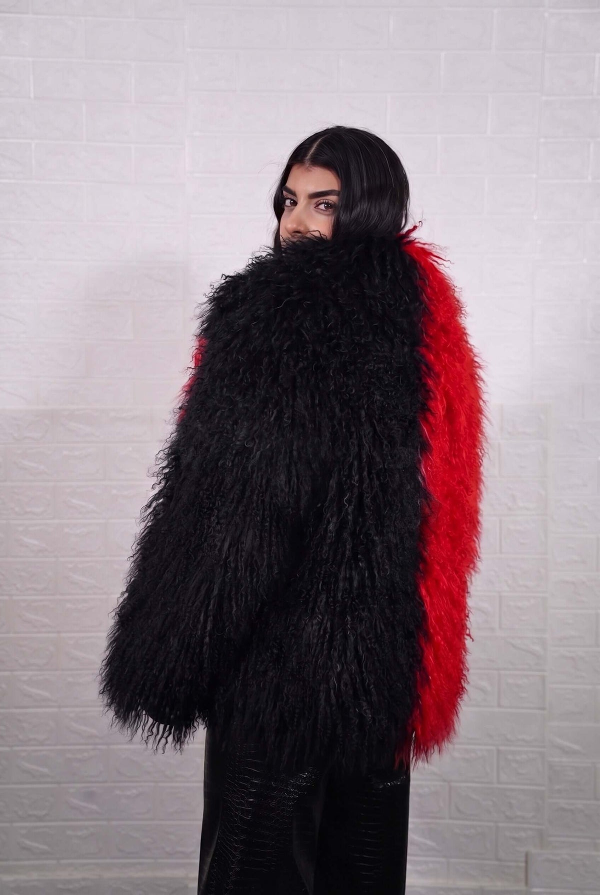 Mongolian jacket red black shown from the back displaying full hip level silhouette and consistent bold scarlet red with jet black curly wool surface — Greek craftsmanship, TatiFurs