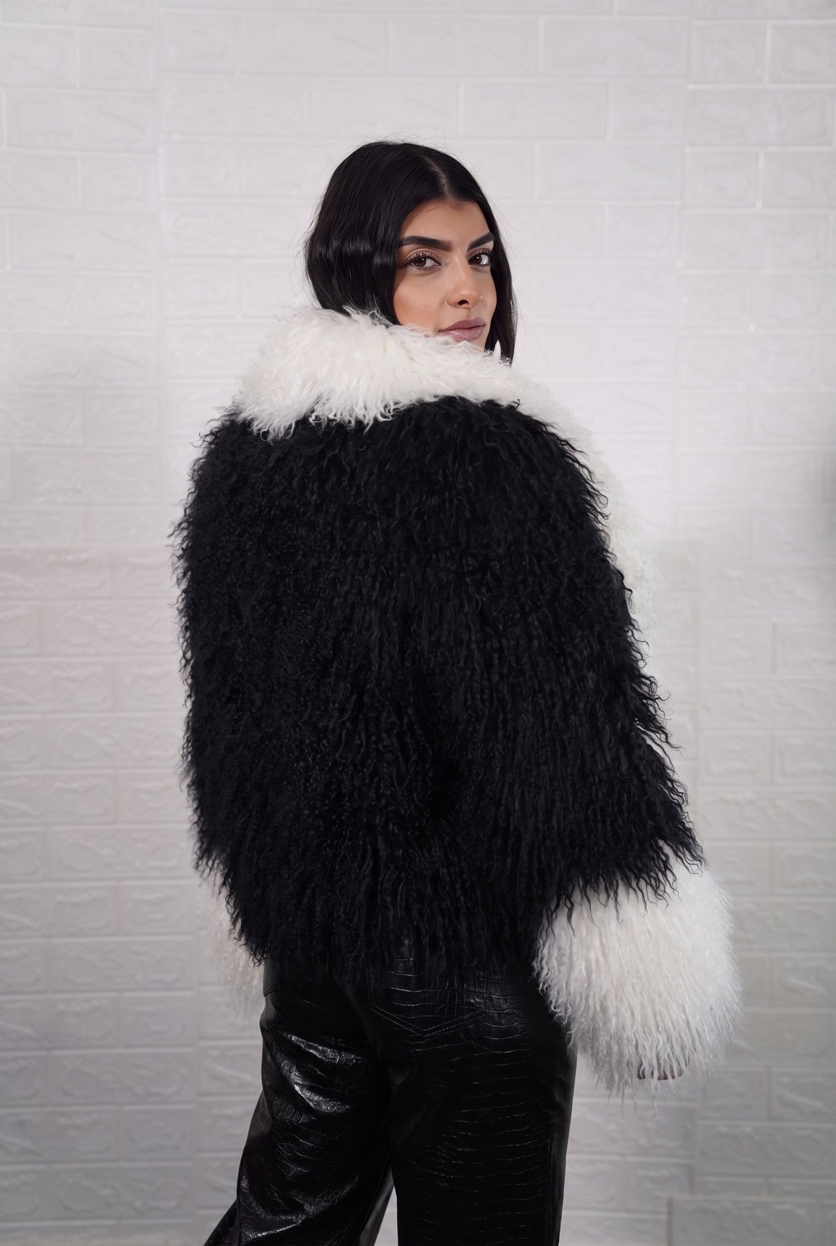 Mongolian jacket black and white women three-quarter view displaying collar frame and voluminous jet black with ivory white Mongolian wool sheepskin — Greek craftsmanship, TatiFurs