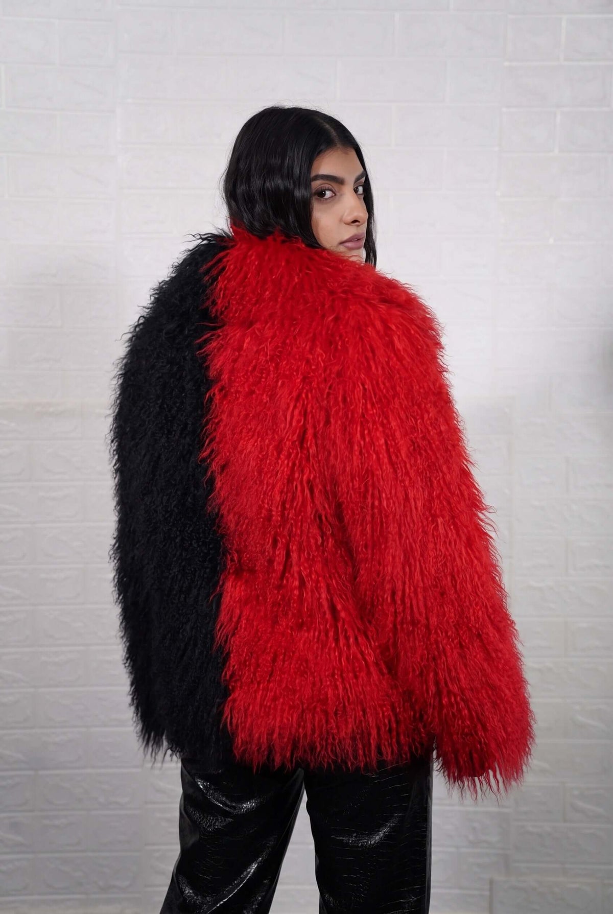 Mongolian jacket red black women three-quarter view displaying collar frame and voluminous bold scarlet red with jet black Mongolian wool sheepskin — Greek craftsmanship, TatiFurs