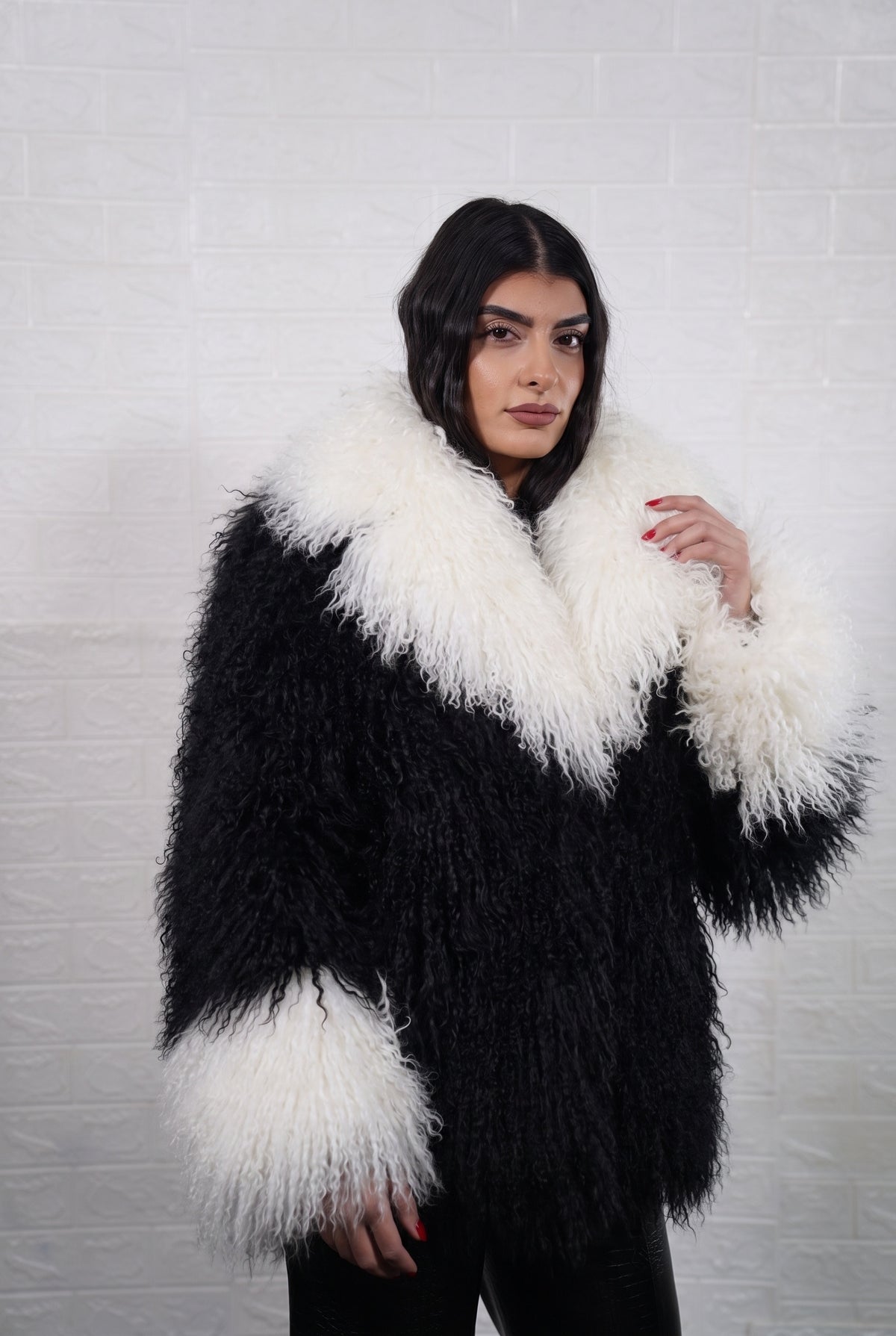 Mongolian jacket black and white women shown from the front displaying collar frame and button closure in jet black with ivory white Mongolian wool sheepskin — Greek craftsmanship, TatiFurs
