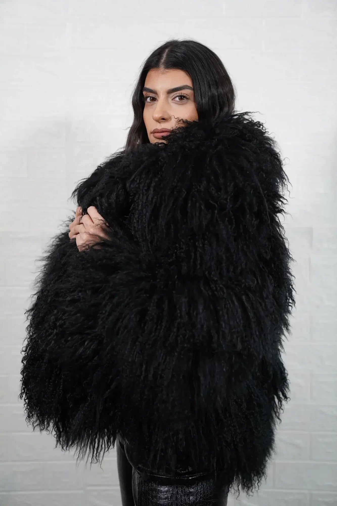 Mongolian jacket black displaying deep commanding black sheepskin leather exterior and hip level collar silhouette — Greek craftsmanship, TatiFurs
