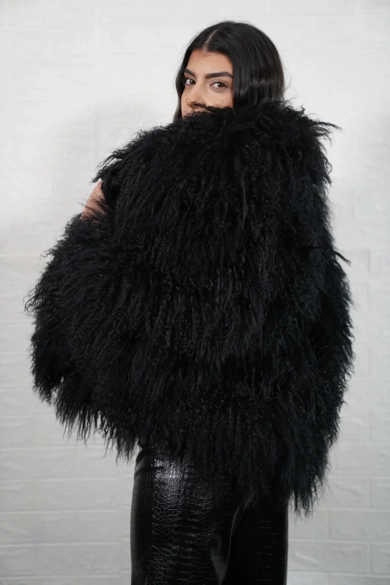 Mongolian jacket black women shown full length from front displaying collar frame and button closure in deep black Mongolian wool sheepskin — Greek craftsmanship, TatiFurs
