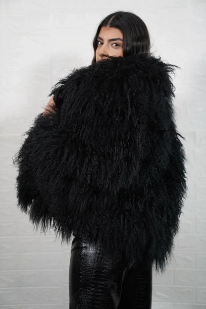 Mongolian jacket black women shown full length from front displaying collar frame and button closure in deep black Mongolian wool sheepskin — Greek craftsmanship, TatiFurs
