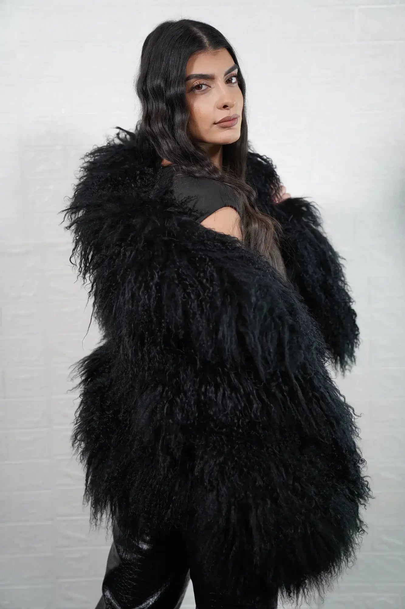 Mongolian jacket black collar close-up showing precise skin matching between collar and shoulder in deep black Mongolian wool sheepskin — Greek craftsmanship, TatiFurs
