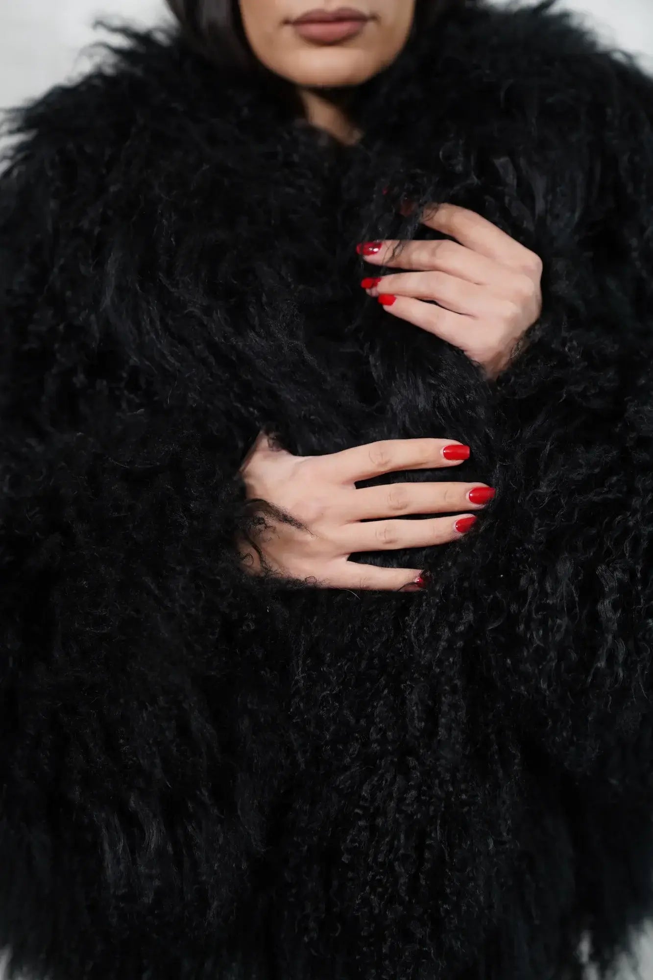 Mongolian jacket black close-up texture showing black sheepskin leather exterior and natural wool lining quality — Greek craftsmanship, TatiFurs
