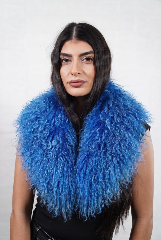 Mongolian Sheepskin Collar Blue — Curly Lamb Fur worn by a woman, front view of the long curly rich cobalt blue Tibetan lamb fur framing the face and shoulders, TatiFurs