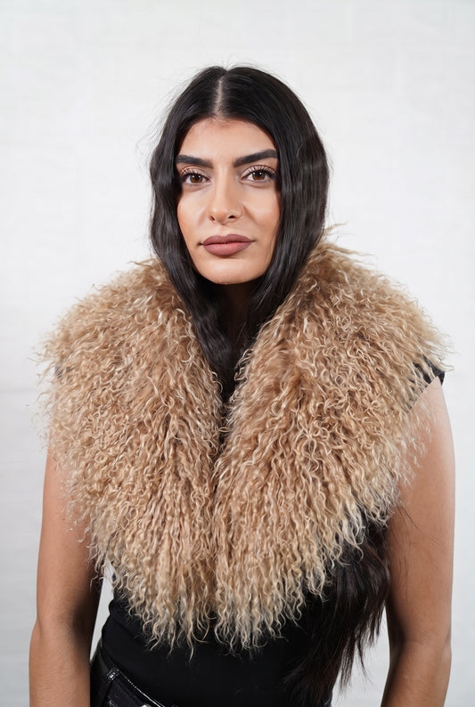 Mongolian Sheepskin Collar Light Brown — Curly Lamb Fur worn by a woman, front view of the long curly milky caramel light brown Tibetan lamb fur framing the face and shoulders, TatiFurs